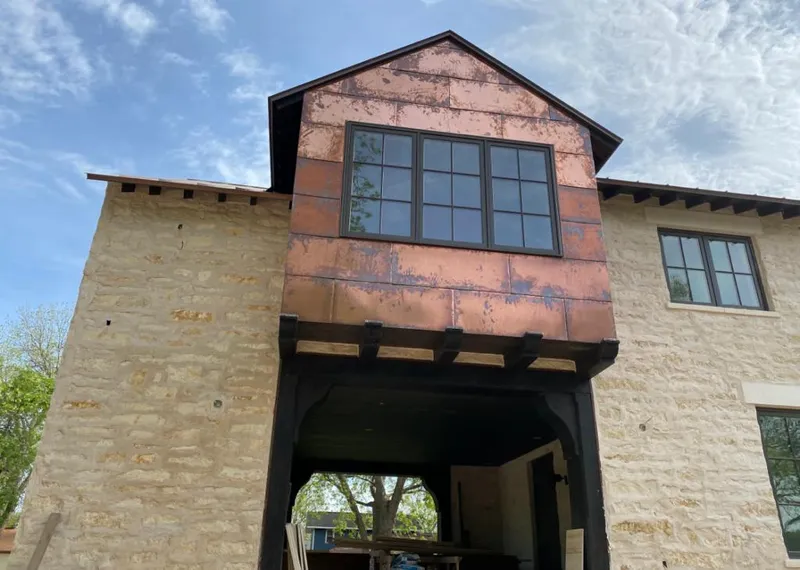Copper metal panel facade on a stone building for Skylight Installation in Eagan