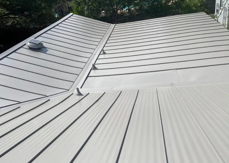 Solar attic fan installed on a metal roof for Roof Ventilation in Eagan
